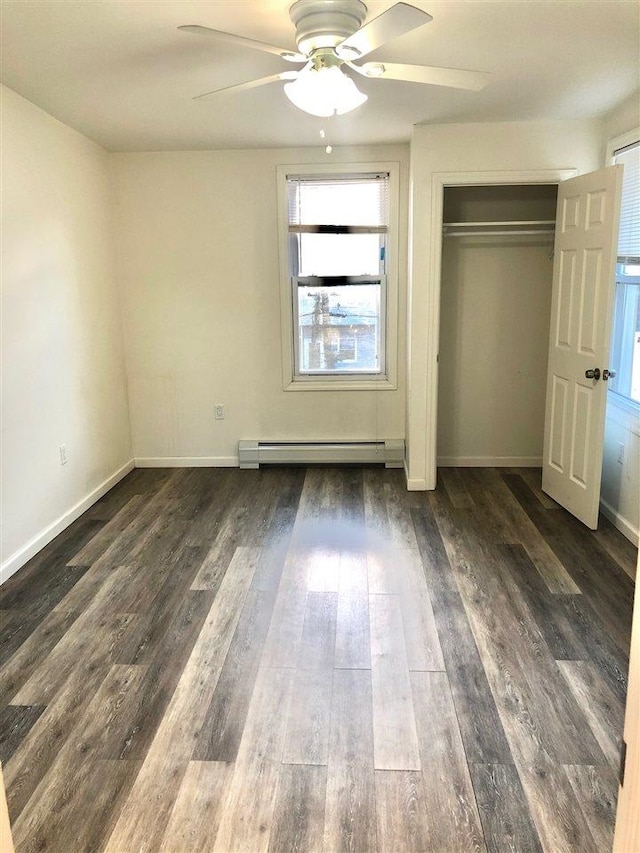 549 Pavonia Ave Unit 1 & 2, Jersey City, NJ 07306 - unfurnished bedroom with a baseboard heating unit, dark wood-style flooring, a closet, baseboards, and ceiling fan