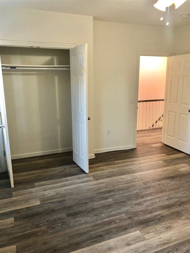 549 Pavonia Ave Unit 1 & 2, Jersey City, NJ 07306 - unfurnished bedroom featuring dark wood-style flooring, a closet, and baseboards