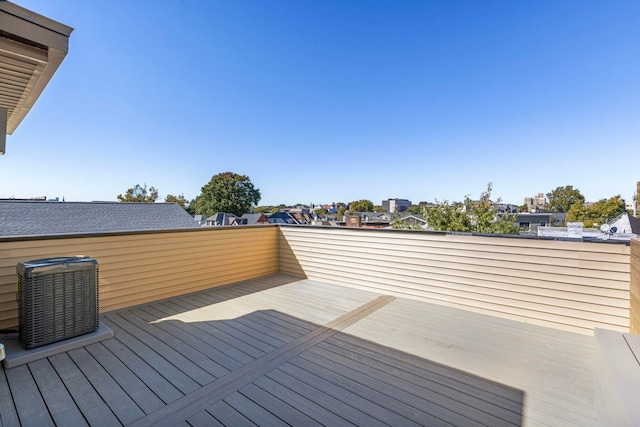 wooden deck featuring cooling unit