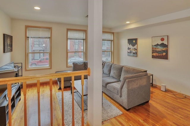 living area with recessed lighting, baseboards, and wood finished floors