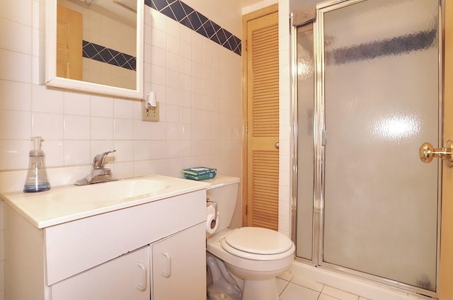 full bath with tile patterned floors, a stall shower, tile walls, and vanity