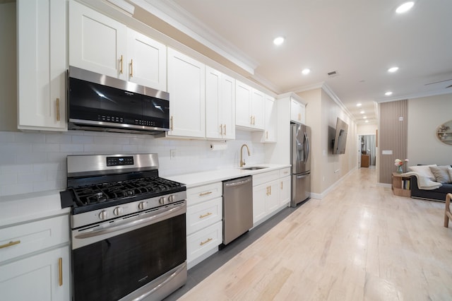 549 Palisade Ave Unit 2, Jersey City, NJ 07307 - kitchen with stainless steel appliances, crown molding, light countertops, recessed lighting, and decorative backsplash