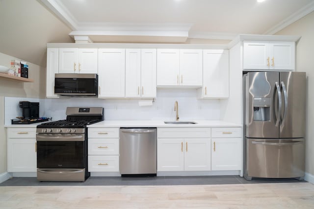 549 Palisade Ave Unit 2, Jersey City, NJ 07307 - kitchen with appliances with stainless steel finishes, ornamental molding, backsplash, white cabinetry, and light countertops