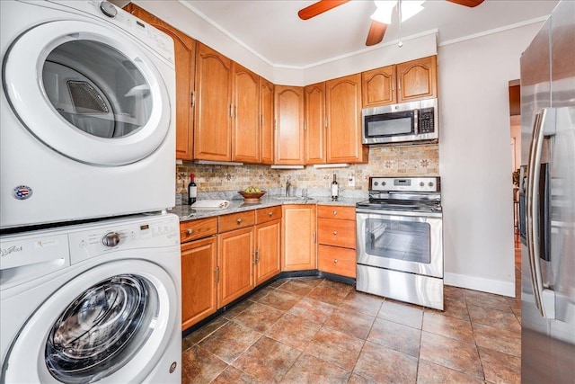 kitchen with stacked washer / dryer, backsplash, stainless steel appliances, and light stone countertops