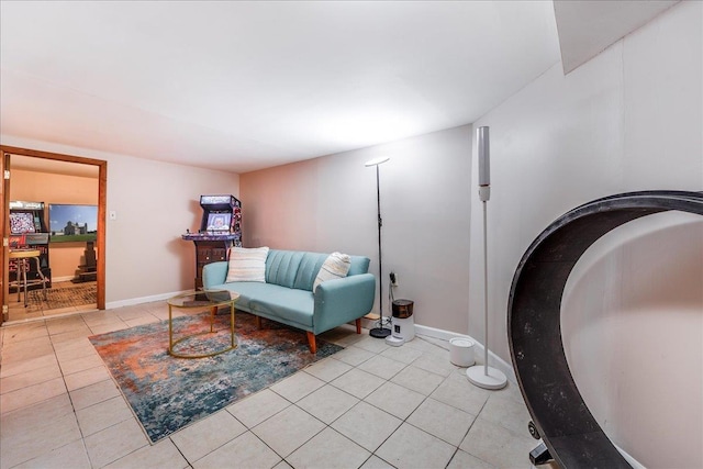 sitting room featuring light tile patterned floors and baseboards