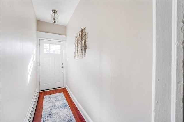 doorway featuring wood finished floors and baseboards