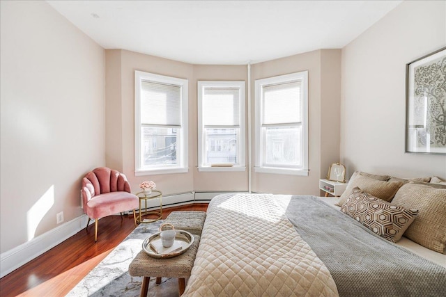 bedroom with baseboards and wood finished floors