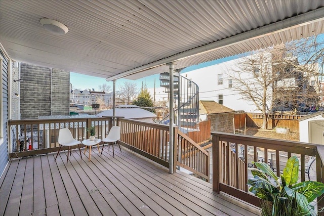 deck with a storage unit, an outdoor structure, and fence