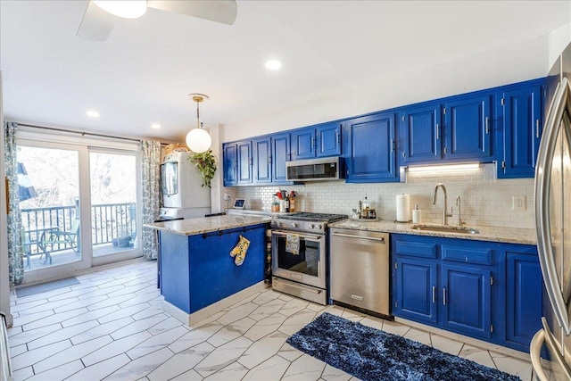 kitchen with stainless steel appliances, blue cabinets, and a sink