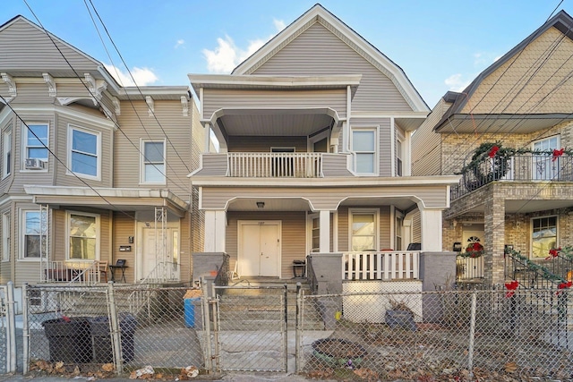 view of property featuring a balcony and a porch