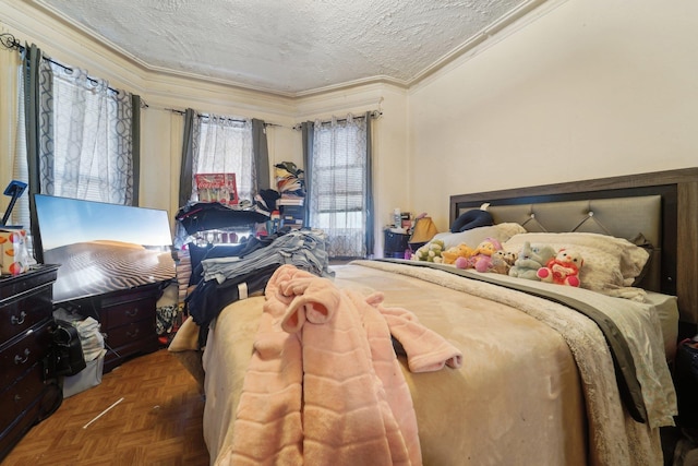 bedroom with crown molding, a textured ceiling, and parquet floors