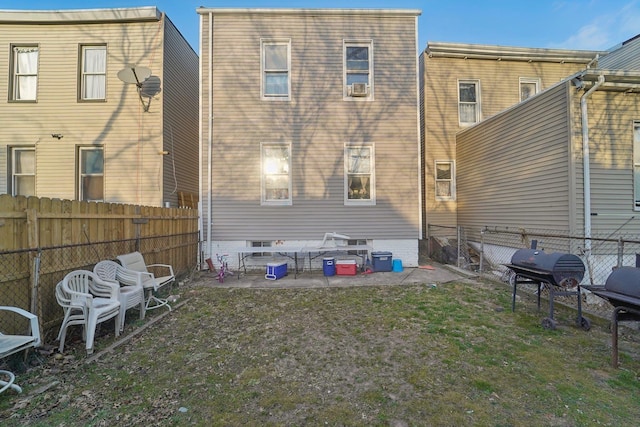 back of property featuring a patio area and a lawn