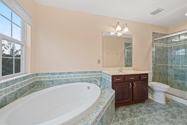 full bathroom with visible vents, a shower stall, a bath, and vanity