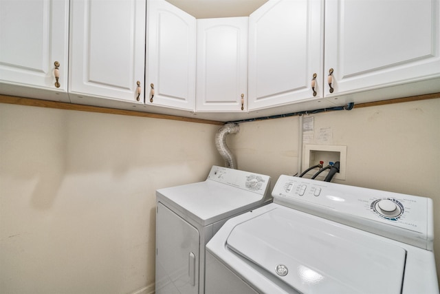 clothes washing area with cabinet space and independent washer and dryer