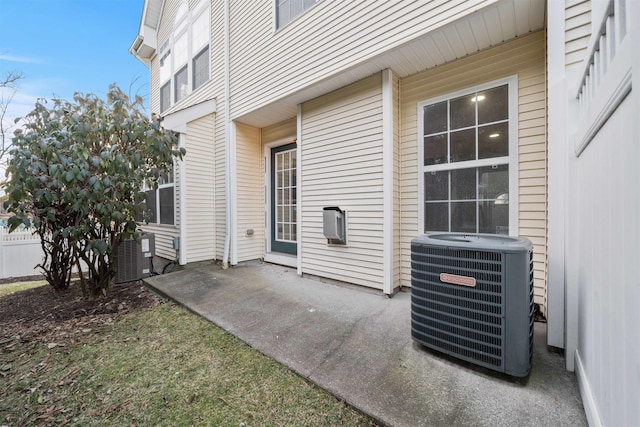 view of patio with central AC unit and fence