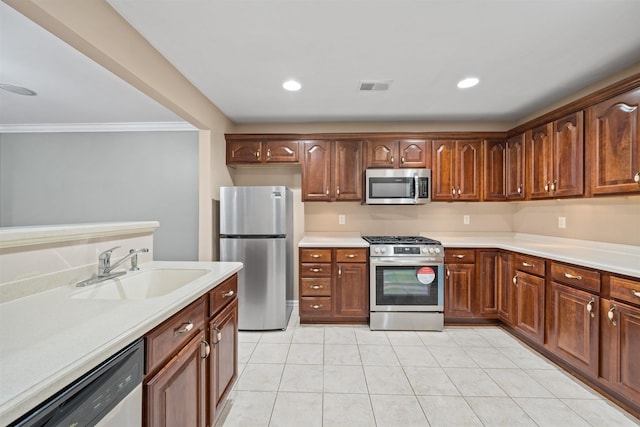 kitchen with light tile patterned floors, visible vents, a sink, light countertops, and appliances with stainless steel finishes