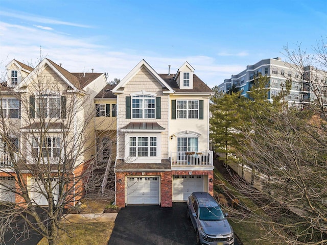 view of front facade featuring aphalt driveway, an attached garage, and brick siding