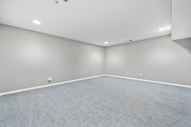 unfurnished room with carpet flooring, recessed lighting, visible vents, and baseboards