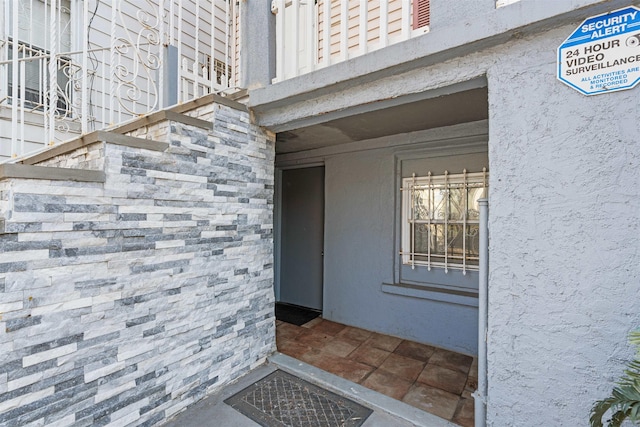 property entrance with stucco siding