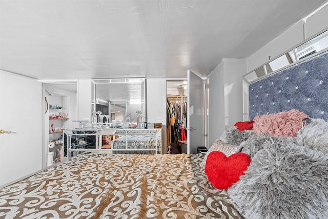 bedroom with a walk in closet and a closet