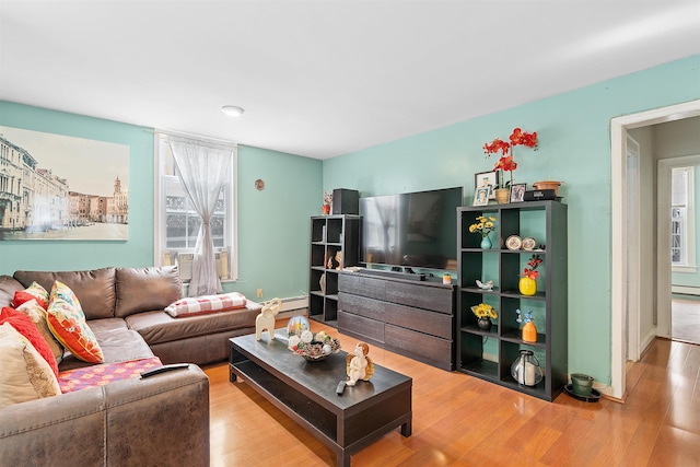 living area with a baseboard radiator and light wood-style floors