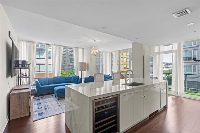 1200 Avenue At Port Imperial Unit 301, Weehawken, NJ 07086 - kitchen featuring a sink, beverage cooler, dark wood-style flooring, healthy amount of natural light, and a wall of windows