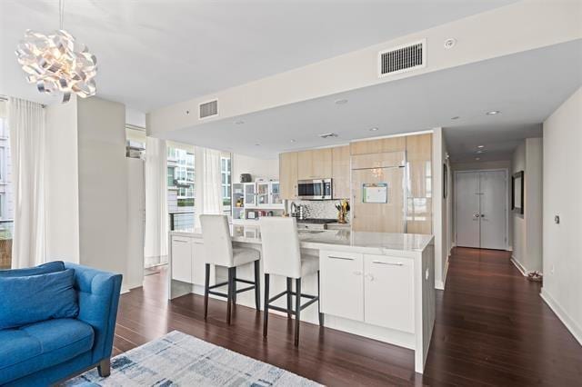 1200 Avenue At Port Imperial Unit 301, Weehawken, NJ 07086 - kitchen featuring stainless steel microwave, paneled refrigerator, dark wood-style floors, light countertops, and open floor plan