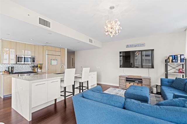 1200 Avenue At Port Imperial Unit 301, Weehawken, NJ 07086 - living room featuring dark wood-type flooring, a chandelier, and baseboards