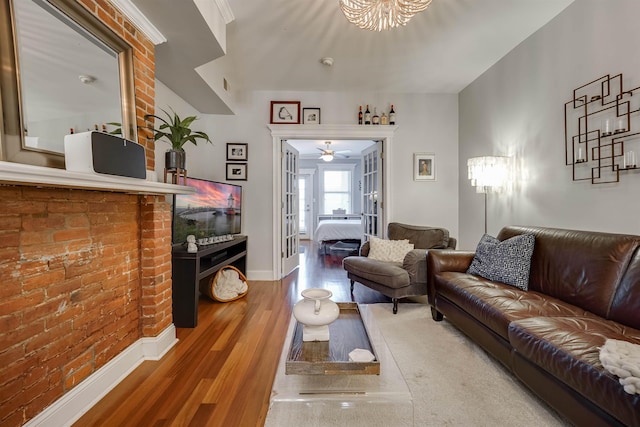 380 7th St Unit 2A, Jersey City, NJ 07302 - living area featuring wood finished floors, brick wall, and ceiling fan