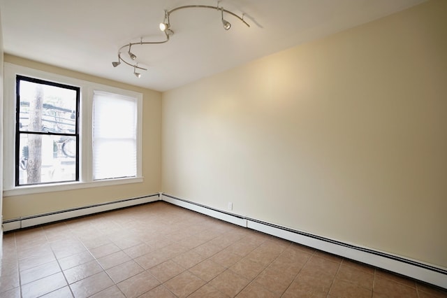 6034 Palisade Ave, West New York, NJ 07093 - tiled empty room featuring baseboard heating, healthy amount of natural light, and rail lighting