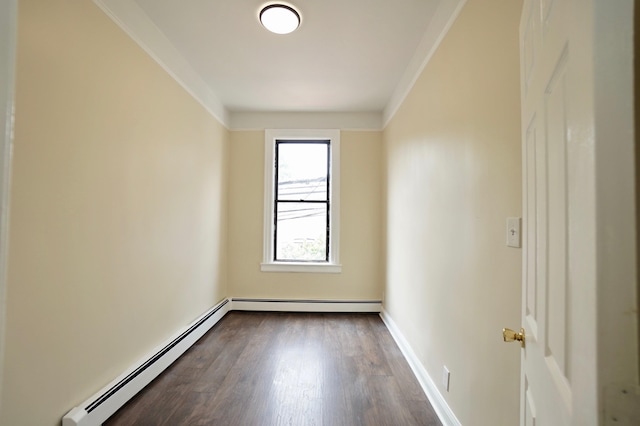 6034 Palisade Ave, West New York, NJ 07093 - empty room featuring a baseboard heating unit, dark wood-style floors, and ornamental molding
