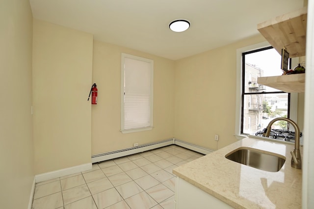 6034 Palisade Ave, West New York, NJ 07093 - kitchen with a baseboard heating unit, light stone counters, and light tile patterned flooring