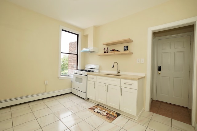 6034 Palisade Ave, West New York, NJ 07093 - kitchen featuring white range with gas stovetop, under cabinet range hood, light tile patterned flooring, white cabinetry, and light countertops