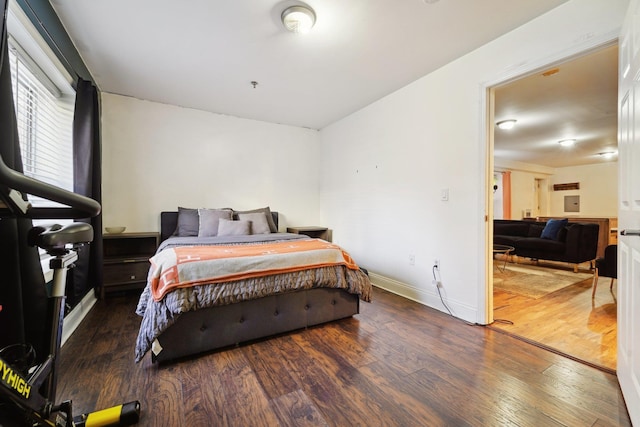 bedroom featuring wood finished floors and baseboards