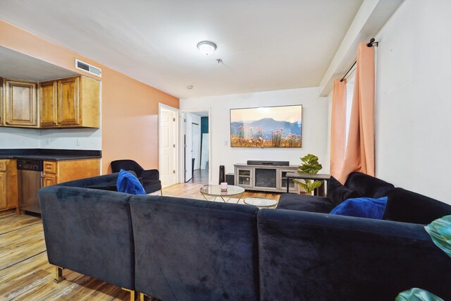 living room featuring visible vents and light wood-style flooring