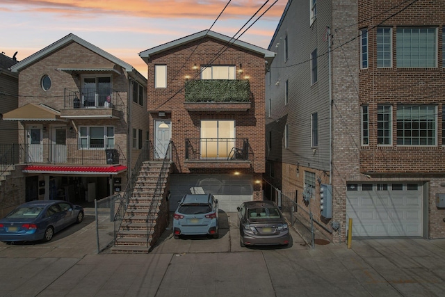 view of front of property featuring concrete driveway, brick siding, and an attached garage