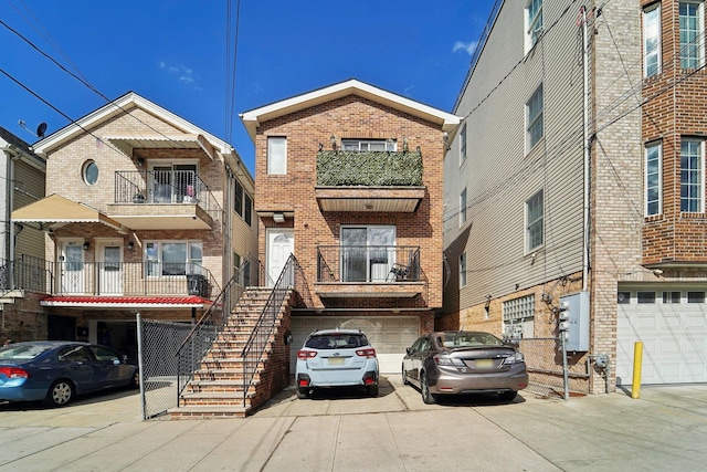 view of building exterior featuring a garage, driveway, and stairs