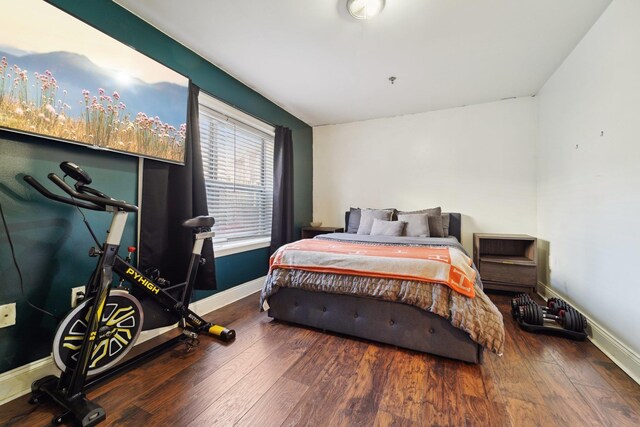 bedroom with wood finished floors and baseboards