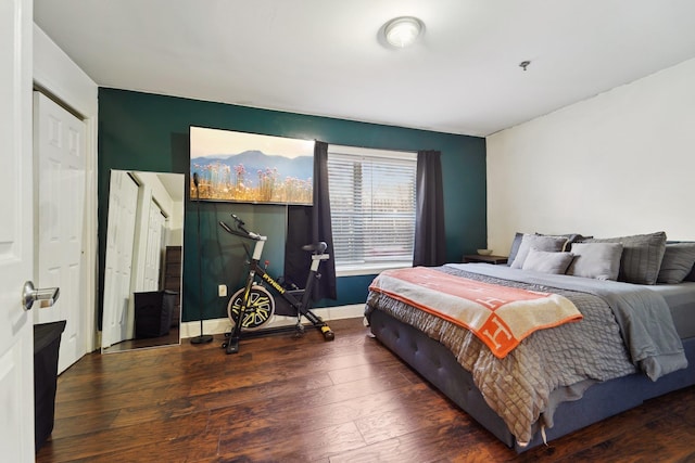 bedroom with baseboards and wood finished floors