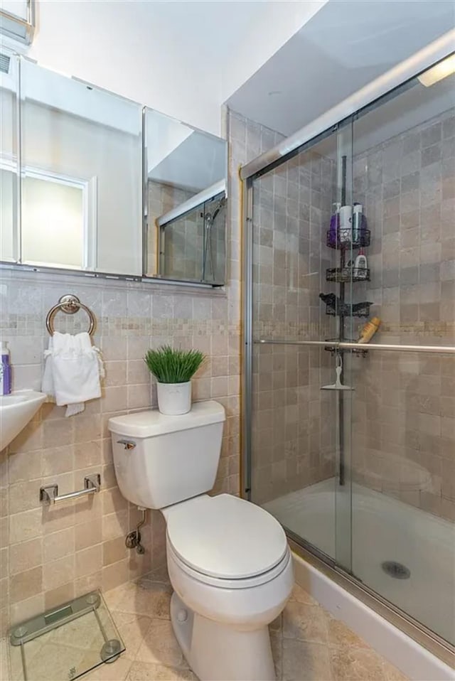 508 Grand St Unit 1L, Hoboken, NJ 07030 - full bath with toilet, a stall shower, tile patterned flooring, and tile walls