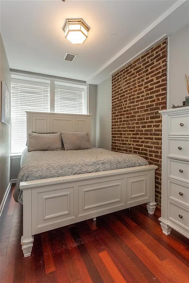 508 Grand St Unit 1L, Hoboken, NJ 07030 - bedroom with dark wood-type flooring and brick wall