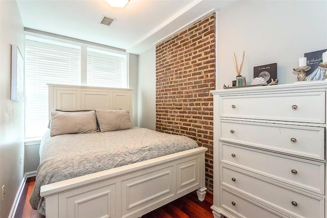 508 Grand St Unit 1L, Hoboken, NJ 07030 - bedroom with dark wood-type flooring and brick wall
