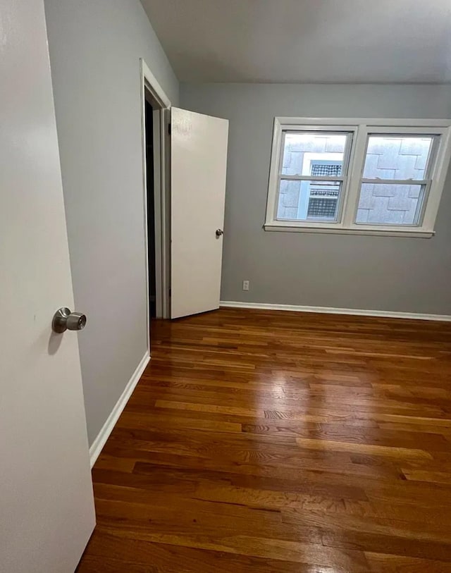 unfurnished bedroom with dark hardwood / wood-style floors