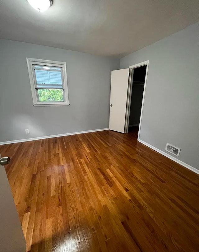 unfurnished room with hardwood / wood-style floors