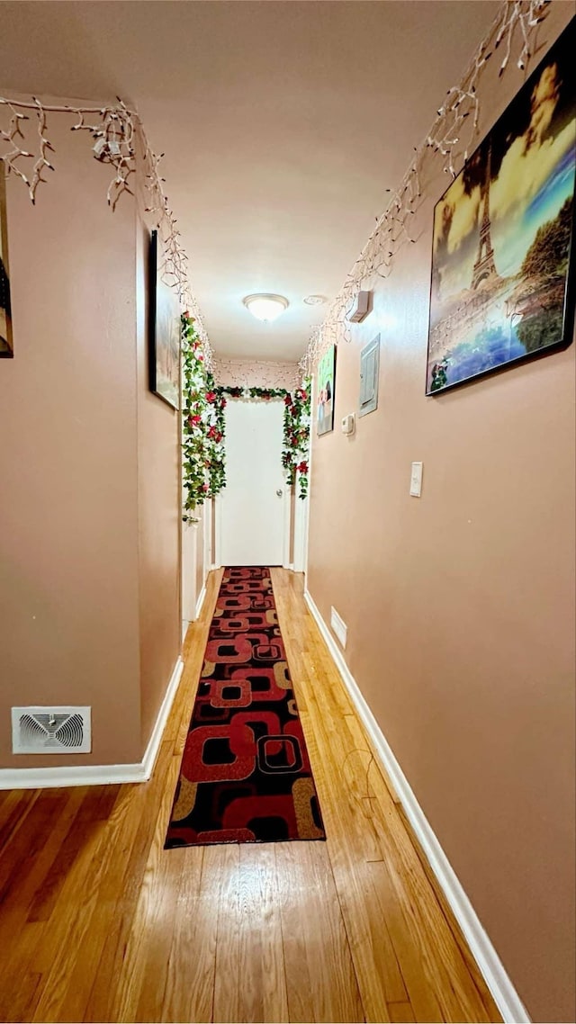 corridor with hardwood / wood-style floors