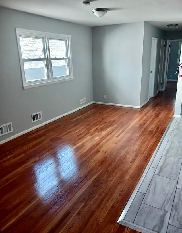 unfurnished room featuring dark hardwood / wood-style floors