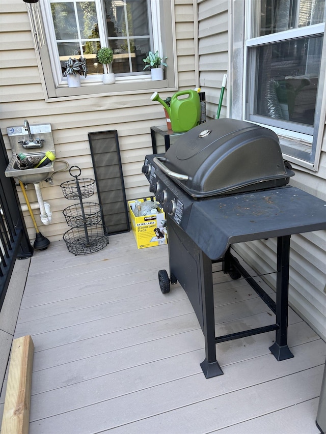 wooden deck with a grill