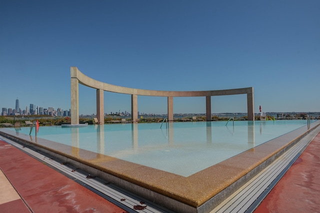 view of pool with a skyline view