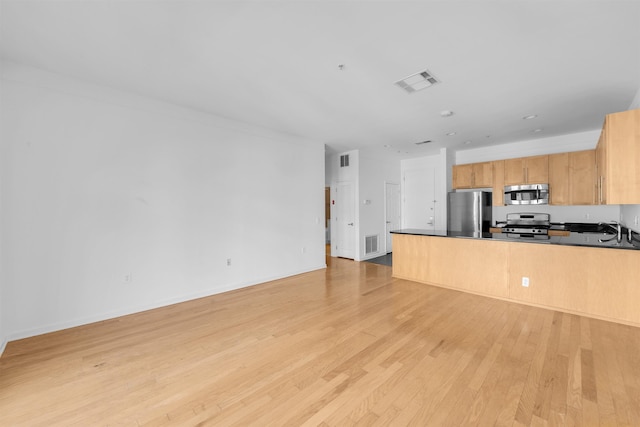 1300 Grand St Unit 521, Hoboken, NJ 07030 - unfurnished living room with light wood finished floors, baseboards, and a sink