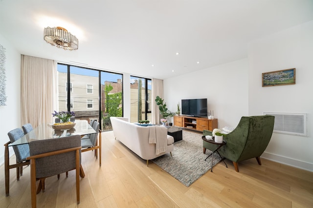 48 Coles St Unit 2, Jersey City, NJ 07302 - living room featuring light wood-style flooring, floor to ceiling windows, recessed lighting, and baseboards